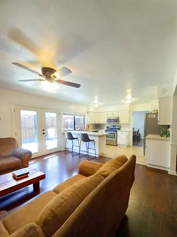 a living room with furniture and kitchen view