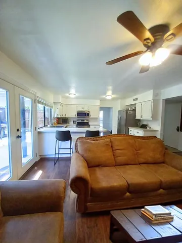 a living room with furniture and kitchen view