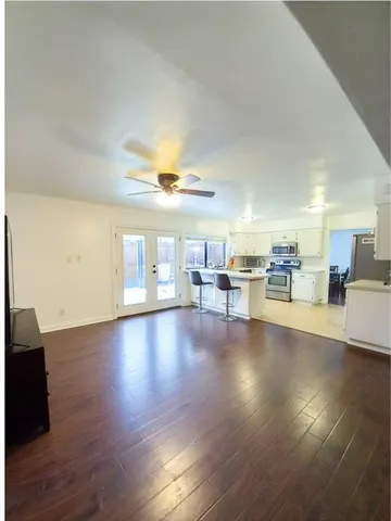 a view of a livingroom with furniture wooden floor and a fireplace
