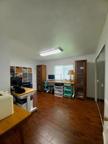 a view of a livingroom with furniture and workspace