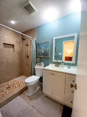 a bathroom with a sink toilet and shower