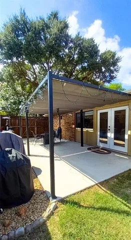 a view of a patio with table and chairs and potted plants