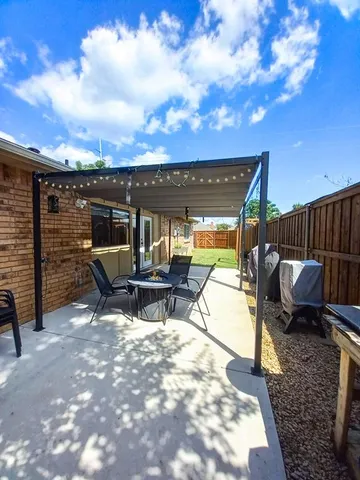 a view of a patio with a table chairs and a fire pit