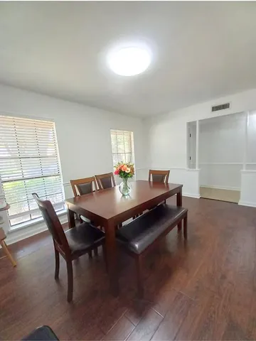 a view of a dining room with furniture and window