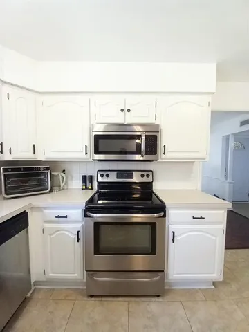 a stove top oven sitting inside of a kitchen