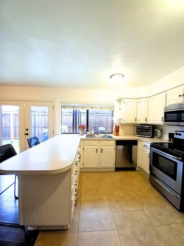 a kitchen with a stove a sink and a refrigerator