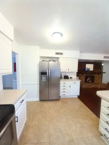 a kitchen with granite countertop a refrigerator and a stove