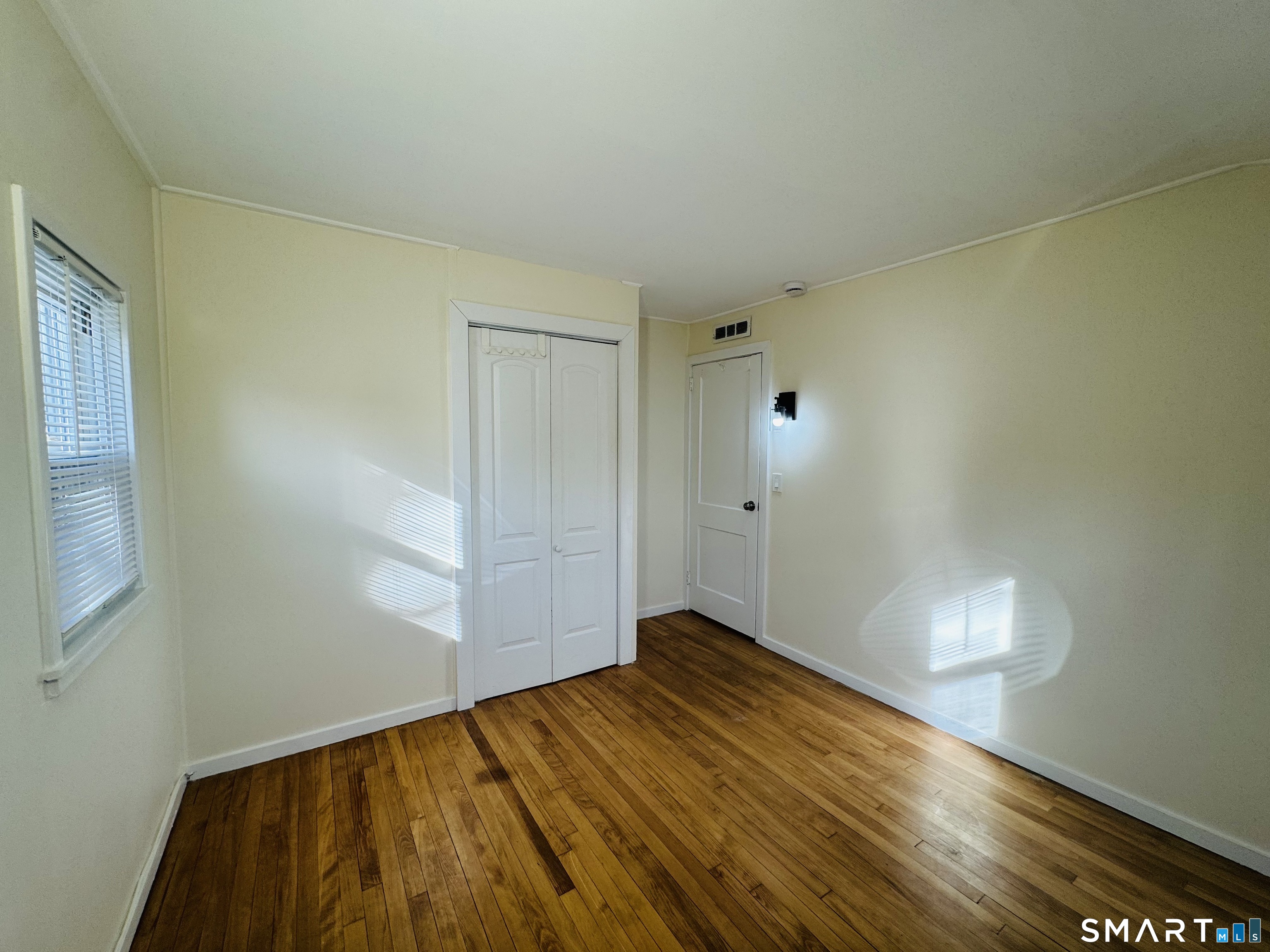 11 Trefoil Court Fairfield, CT 06825 - Photo 11 of 13 a view of empty room with wooden floor