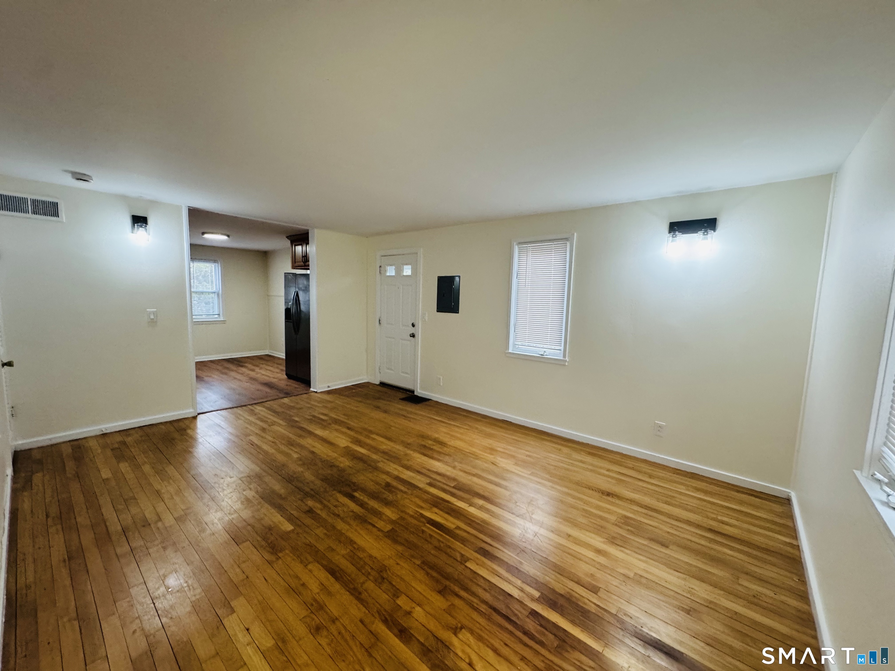 11 Trefoil Court Fairfield, CT 06825 - Photo 4 of 13 a view of empty room with wooden floor