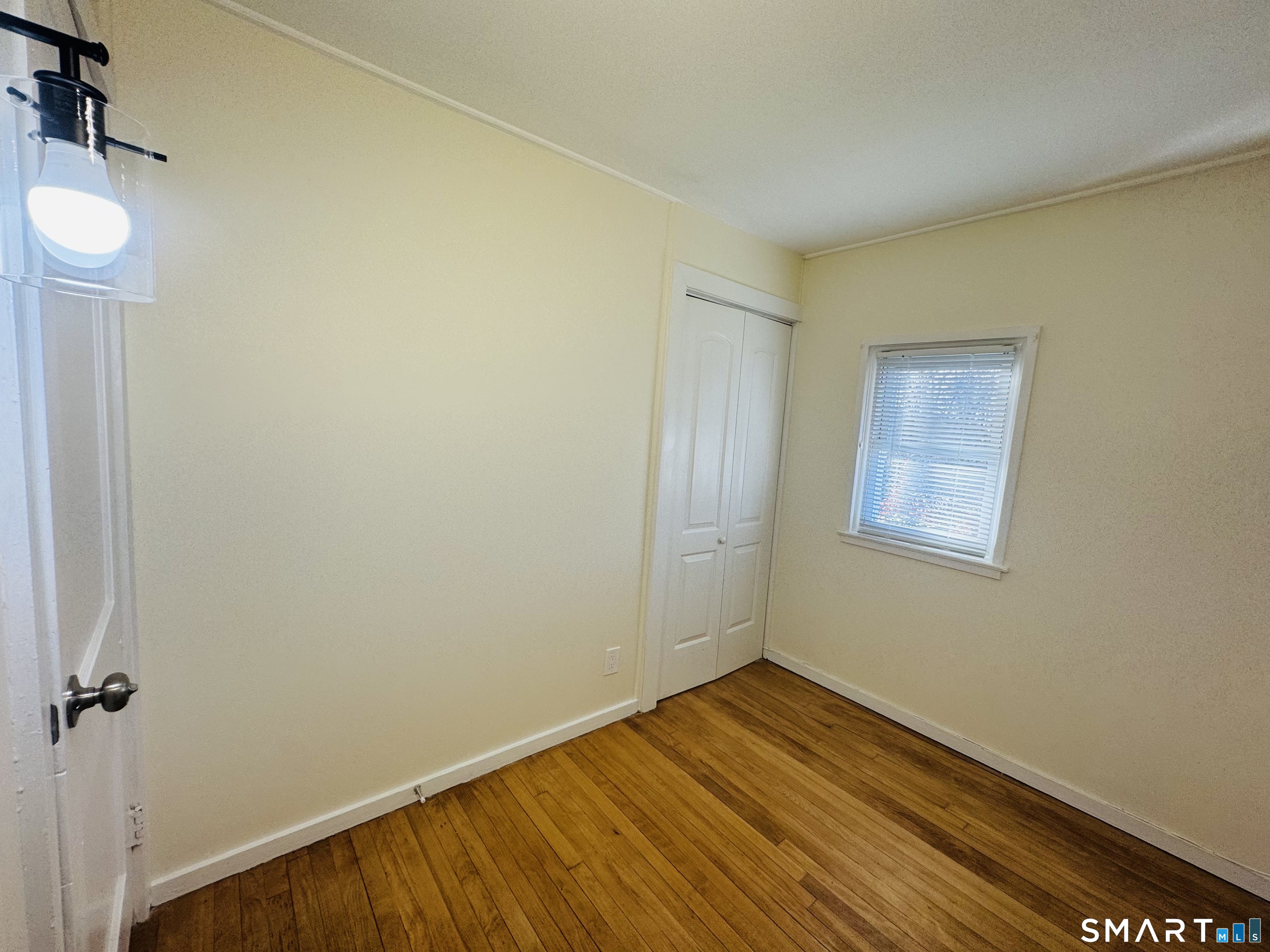 11 Trefoil Court Fairfield, CT 06825 - Photo 9 of 13 a view of a room with wooden floor and a window
