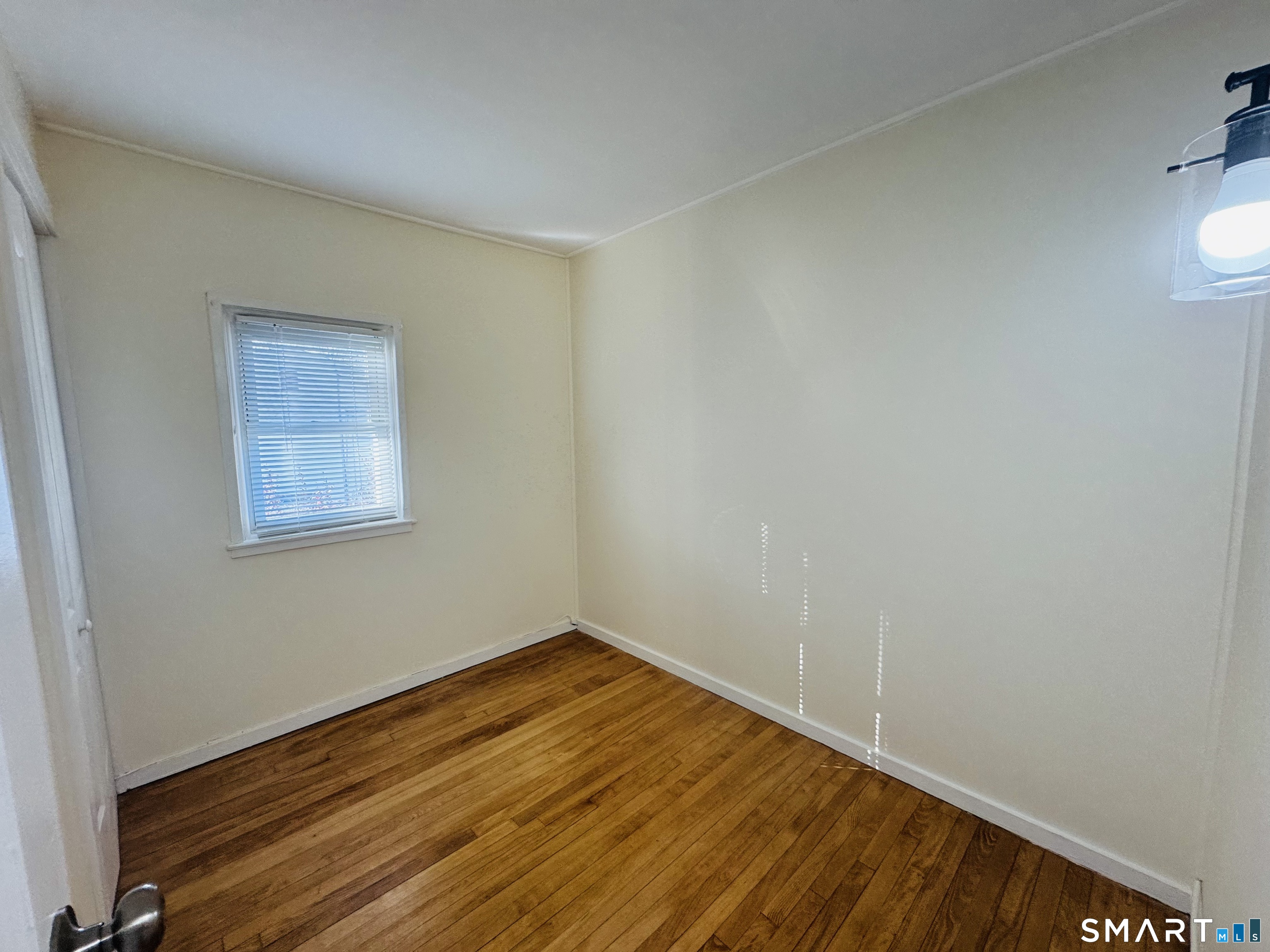 11 Trefoil Court Fairfield, CT 06825 - Photo 10 of 13 a view of empty room with wooden floor