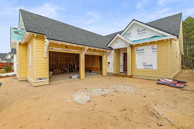 a view of a house with wooden fence