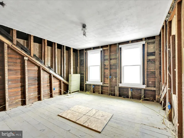 a spacious bedroom with a bed and a large window