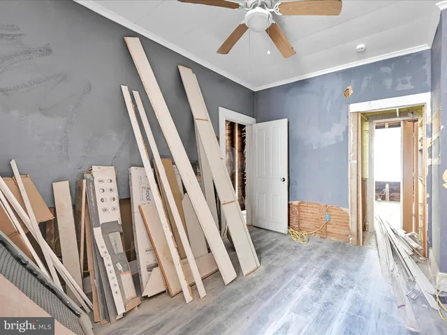 a view of a livingroom with wooden floor and staircase