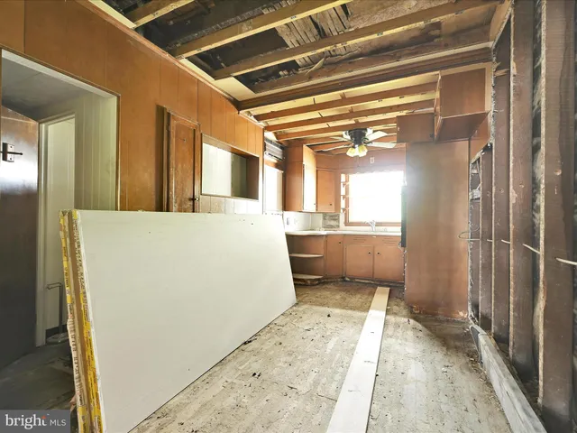 a view of kitchen and hall with wooden floor