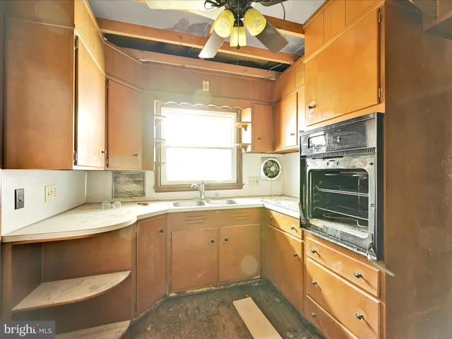 a kitchen with a sink stove and microwave