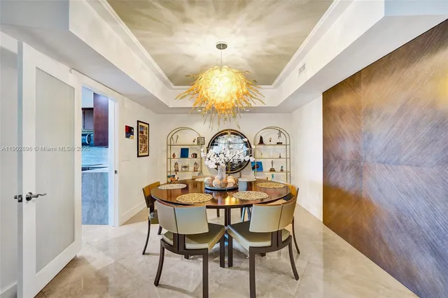 a view of a dining room with furniture and chandelier