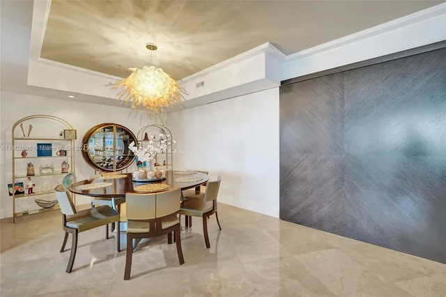 a dining room with furniture and chandelier