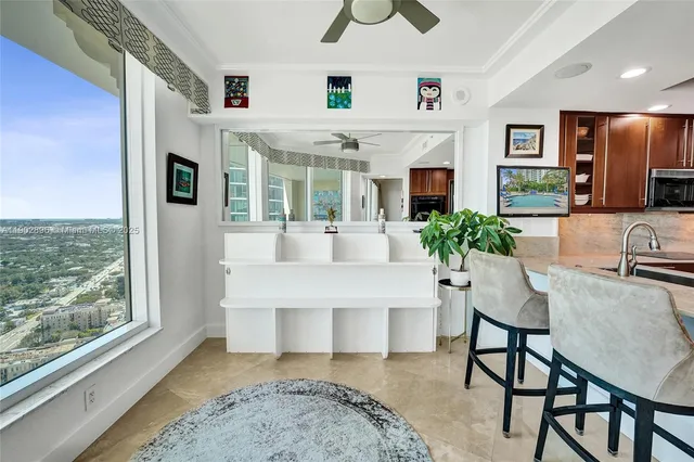 a living room with furniture and a floor to ceiling window