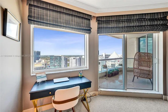 a bedroom with furniture and large window