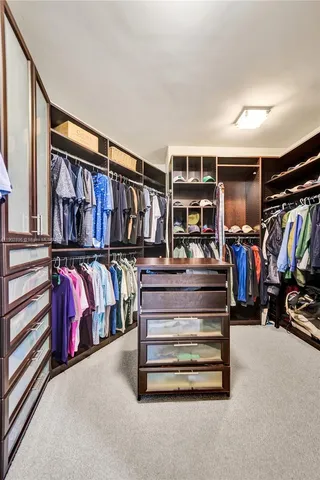 a bedroom with two beds and a chandelier