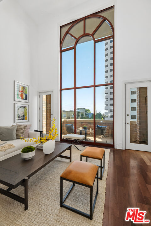 a living room with furniture and a floor to ceiling window