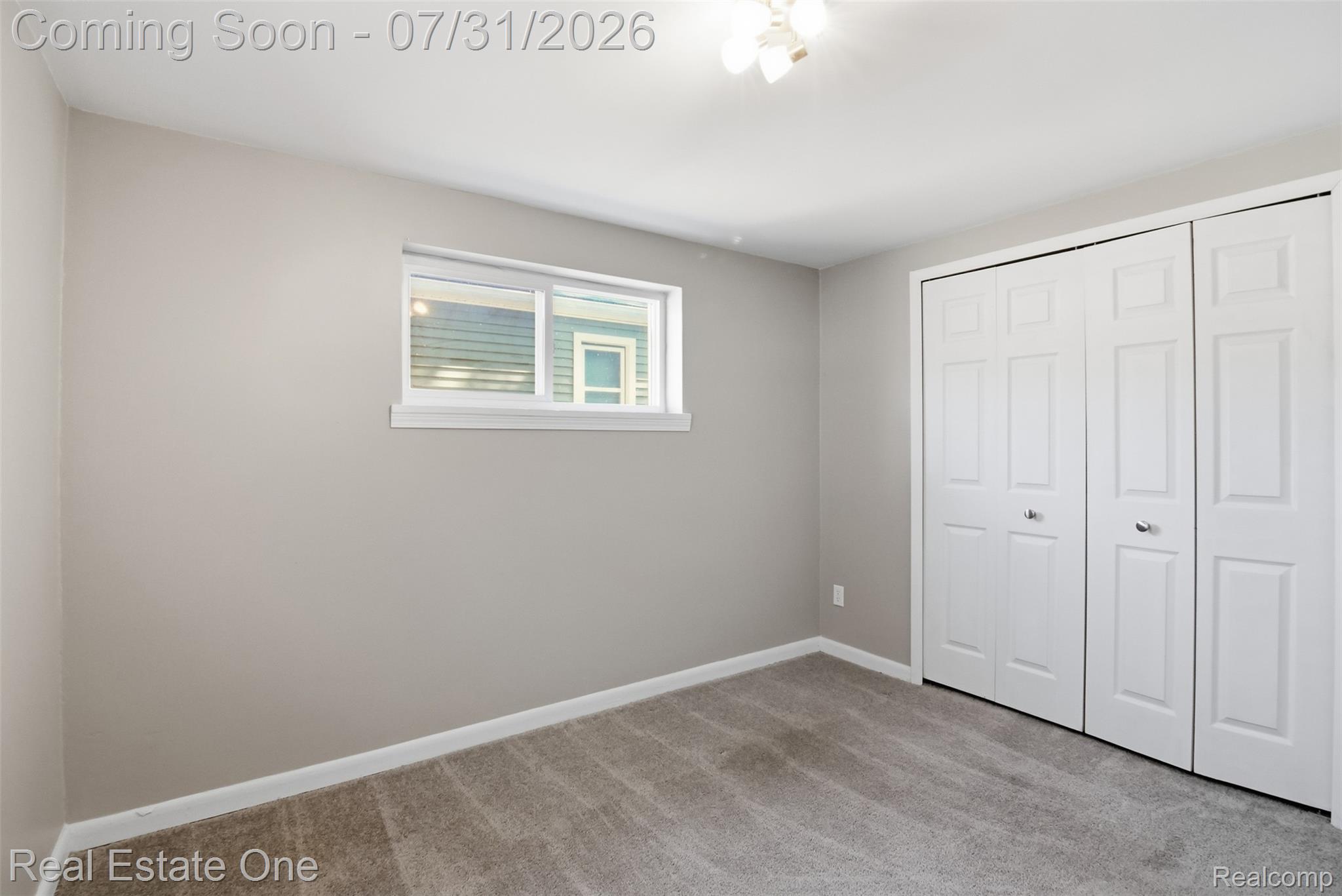 1615 South Commerce Road Walled Lake, MI 48390 - Photo 24 of 34 Room with light gray walls, gray carpet flooring, white baseboards, and a white ceiling