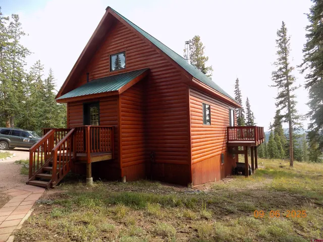 a backyard of a house with barbeque oven table and chairs