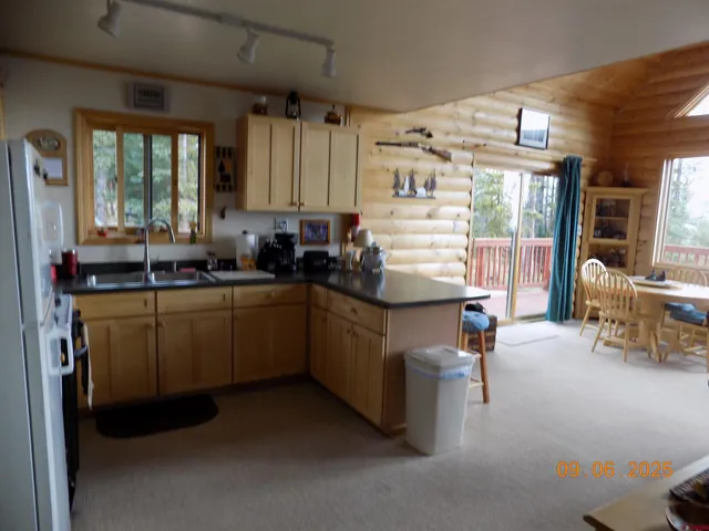 a kitchen with sink cabinets and window