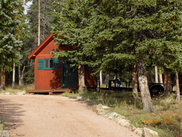 a backyard of a house with barbeque oven table and chairs