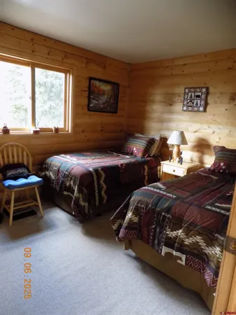 a bedroom with two beds and a window