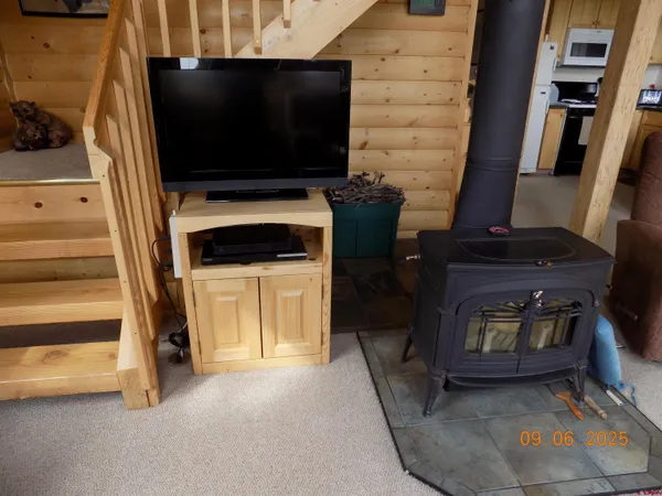a living room with a flat screen tv and a fireplace