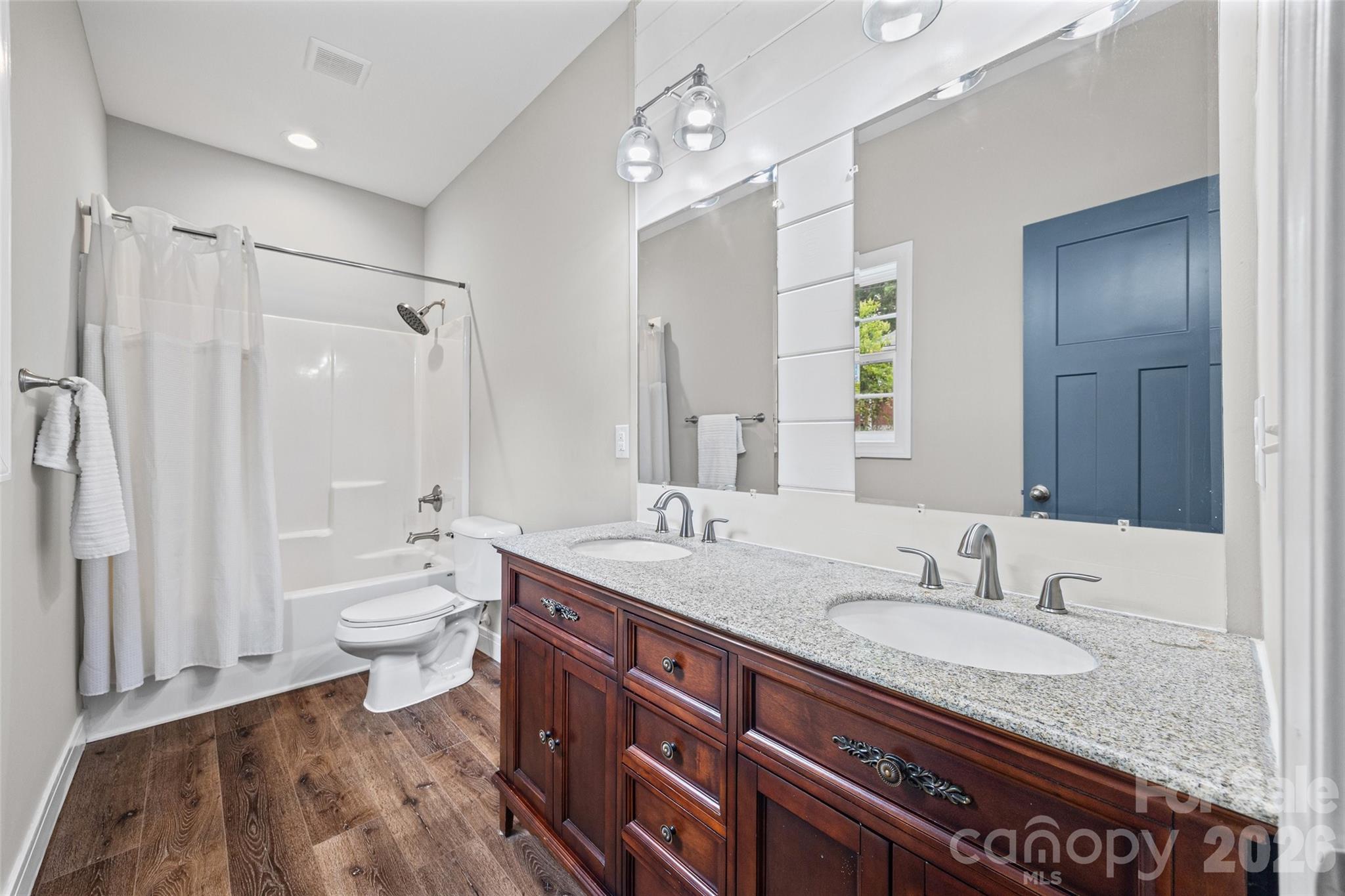103.5 Foote Street Chester, SC 29706 - Photo 15 of 22 a bathroom with a granite countertop sink a toilet a mirror and shower