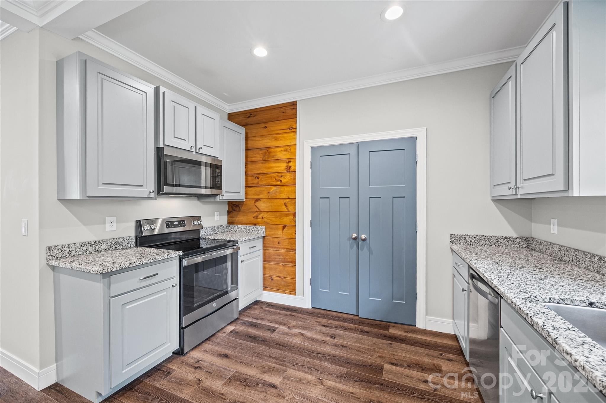 103.5 Foote Street Chester, SC 29706 - Photo 8 of 22 a kitchen with stainless steel appliances granite countertop a stove a sink and a refrigerator