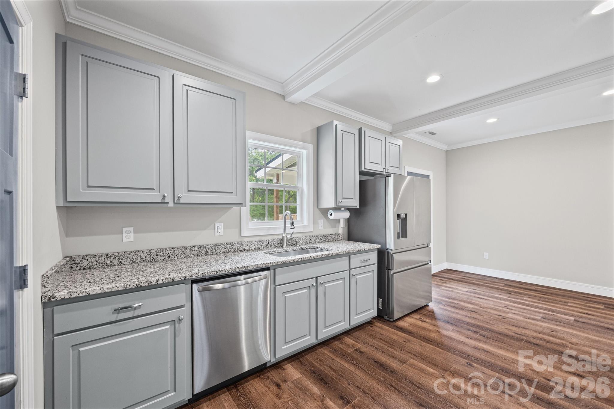 103.5 Foote Street Chester, SC 29706 - Photo 9 of 22 a kitchen with stainless steel appliances granite countertop a sink cabinets and wooden floor