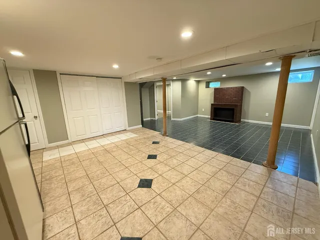 a big room with wooden floor and natural light