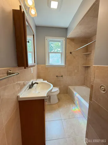 a bathroom with a sink a toilet and mirror