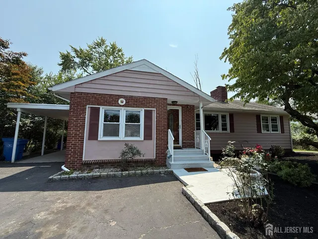 a front view of a house with a yard and outdoor seating