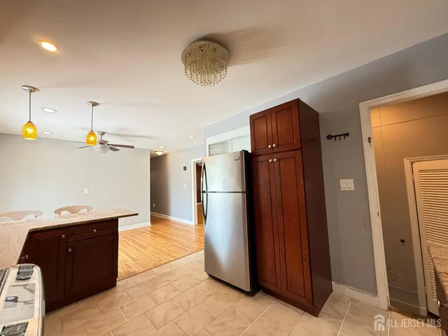 a kitchen with stainless steel appliances granite countertop a refrigerator and a sink