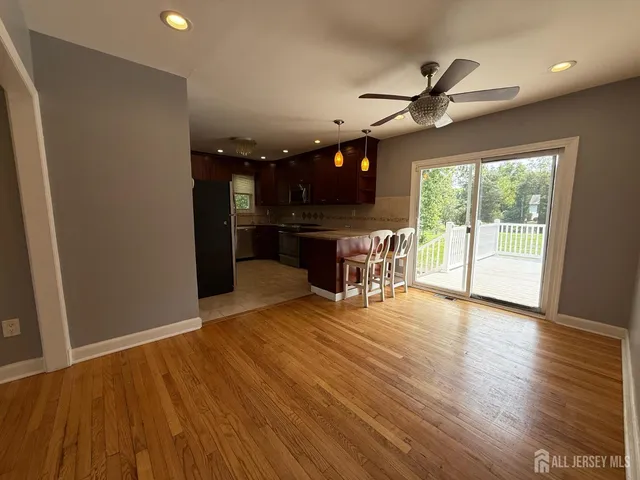 a view of a livingroom with furniture and a ceiling fan