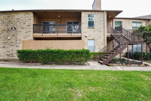 a view of a house with a yard and sitting area