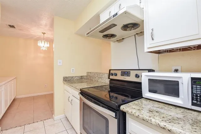 a kitchen with a stove and a microwave