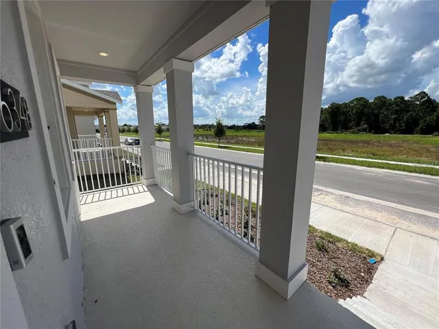 a view of a porch with wooden floor and fence