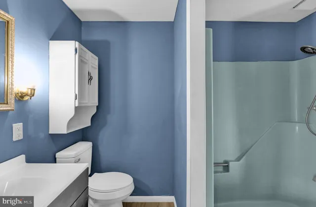 a white toilet sitting next to a bathroom sink