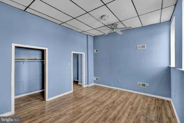 a view of empty room with wooden floor