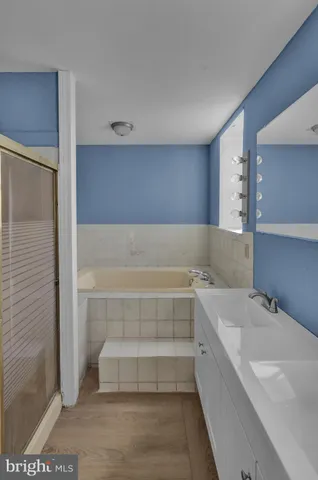 a bathroom with a bathtub and shower