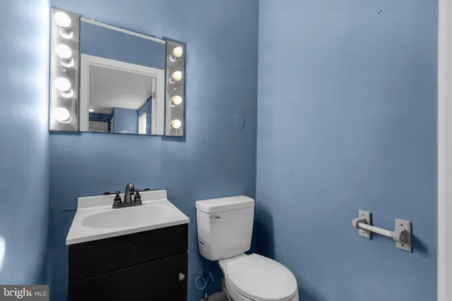 a bathroom with a toilet sink and mirror