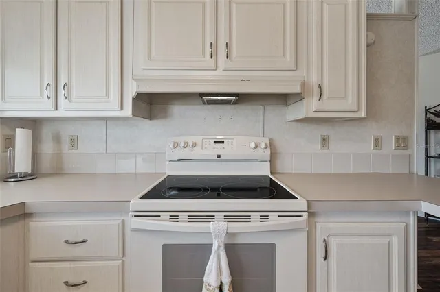 a stove top oven sitting inside of a kitchen