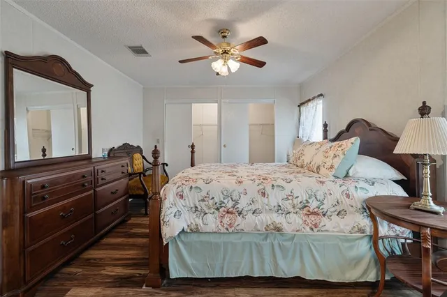 a bedroom with a large bed and a chandelier