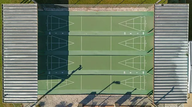 a green room with a shower and a sink